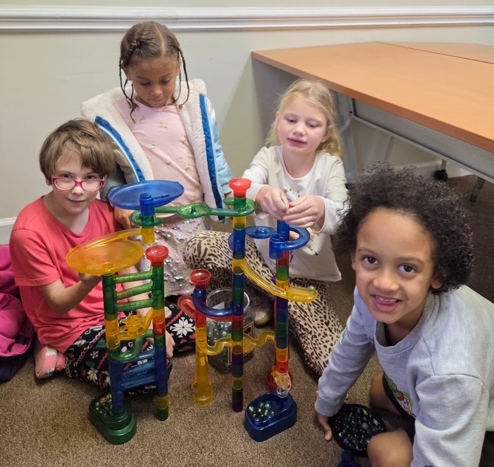 Friends playing with a marble run
